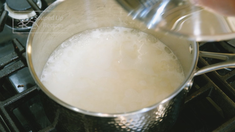 Image of Once it simmers, put on the lid. Switch the heat to low and cook for 18 minutes.