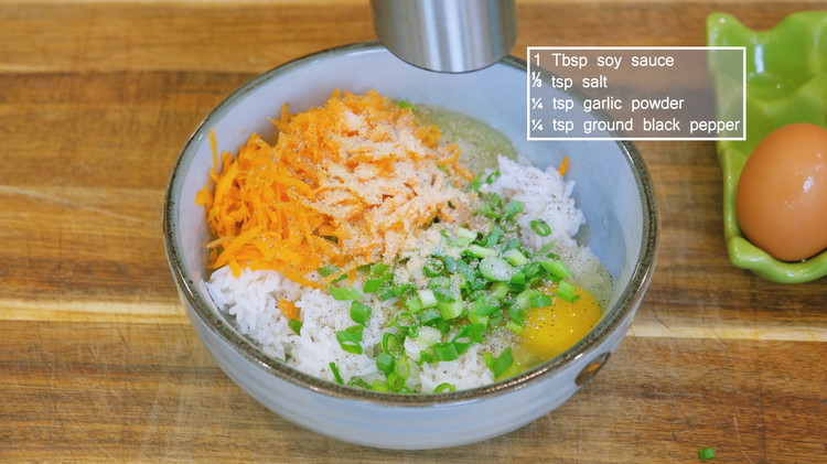 Image of In a mixing bowl, add 1 cup of cooked rice, 3 medium sized eggs, 1/4 cup of diced scallions, 1/4 cup of shredded carrot, 1 tbsp of soy sauce, 1/3 tsp of salt or to taste, 1/4 tsp of garlic...
