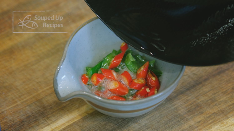 Image of Heat 1.5 Tbsps of pork lard in a wok to smoking hot. Pour 1 tbsp into the little bowl but leave 1/2 tbsp in the wok.