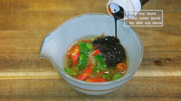 Image of Stir the aromatics to activate the fragrance. Add 1 Tbsp soy sauce, 1/2 tbsp of oyster sauce, and 1 tsp dark soy sauce. Mix well and set it aside.