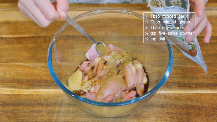 Image of Cut the chicken into bite-size pieces. Marinade it with 1 Tbsp minced garlic, 1/2 Tbsp minced ginger, 2 tbsp soy sauce, 1/2 tsp salt, and 1/2 tsp five-spice powder. Mix well and set it aside. 