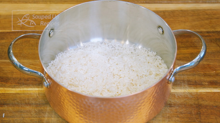 Image of Rinse the jasmine rice with water and drain thoroughly. Add the rice to a pot for now, and we'rewe're gonna cook the chicken.