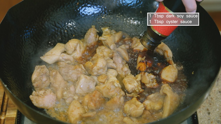 Image of Add the marinated chicken and spread it out. Let it cook until the chicken has changed color. Drizzle in 2 Tbsps of Chinese cooking wine and stir to evaporate the alcohol. Add 1 tbsp dark soy sauce and 1 Tbsp oyster...