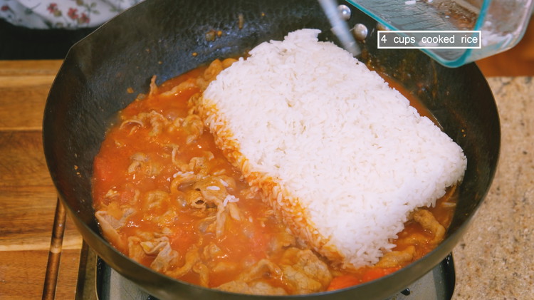 Image of Add the leftover rice and mix until well combined. Turn off the heat. Sprinkle some diced scallions and cilantro as garnish.