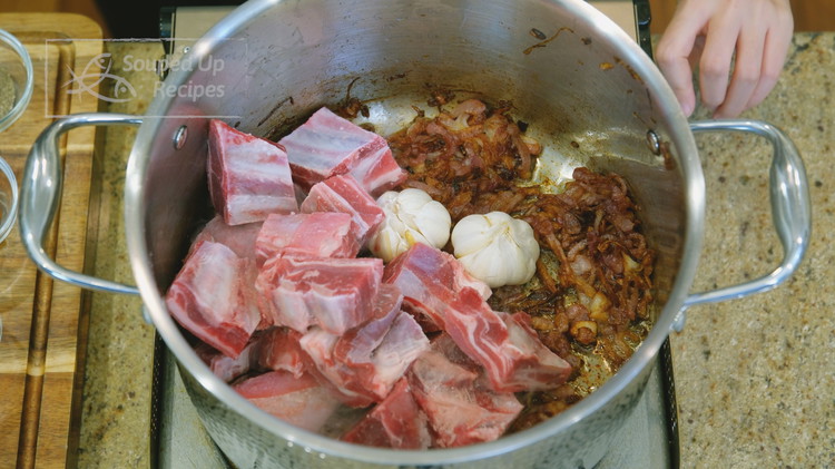 Image of Add the garlic bulbs, carrot sticks, and bone-in lamb meat and stir for 3-4 minutes. If using boneless meat, only need 454g / 1 pound.