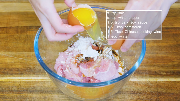 Image of Place the pork in a mixing bowl and add 1/4 tsp of salt, 1/4 tsp of white pepper, 1.5 tsp of dark soy sauce, 1.5 tbsp of cornstarch, 1.5 tbsp of Chinese cooking wine, and 1 egg white. If you...