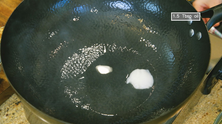 Image of Turn the heat to high and heat the wok until smoking hot. Add 15 Tbsp of pork lard and swirl to melt it. If you don’t like animal fat, you can use vegetable oil.