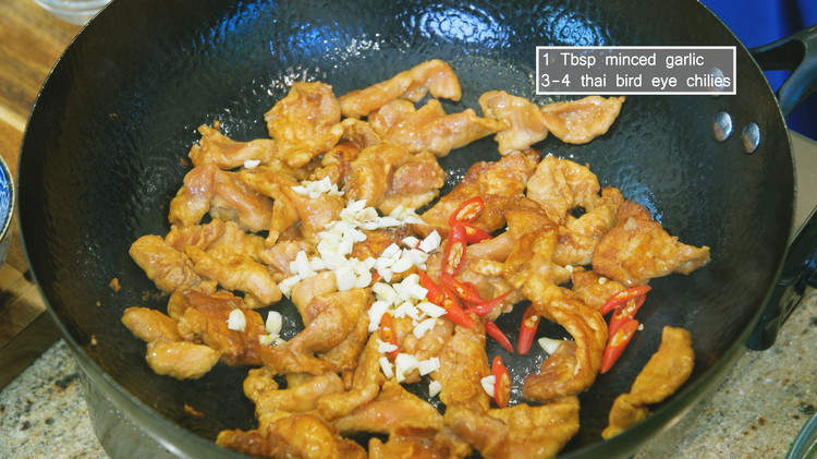 Image of Carefully add the pork and quickly loosen the meat. Sear over high heat for 2-3 minutes. When most of the pork changes color, toss in the garlic and diced Thai bird eye chilies and stir until fragrant. If you can’t...