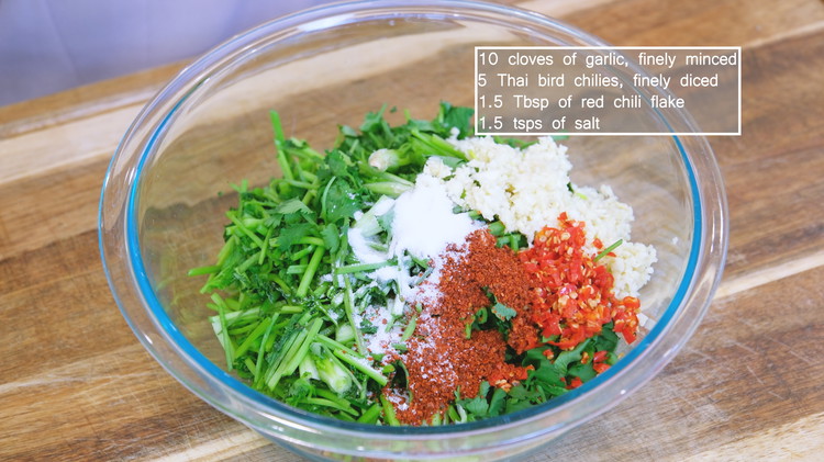 Image of Combine the cilantro with minced garlic, Thai bird eye chilies, red chili flakes, and salt and mix thoroughly.