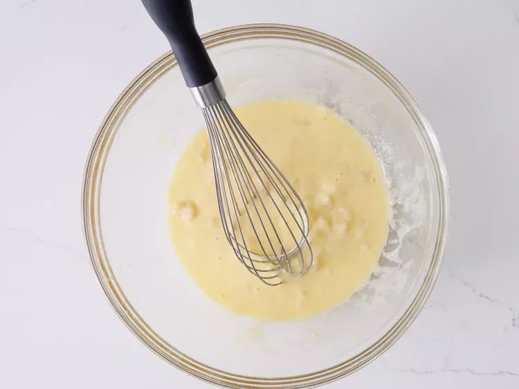 Image of Mix eggs, bananas, oil, and buttermilk together in a large...