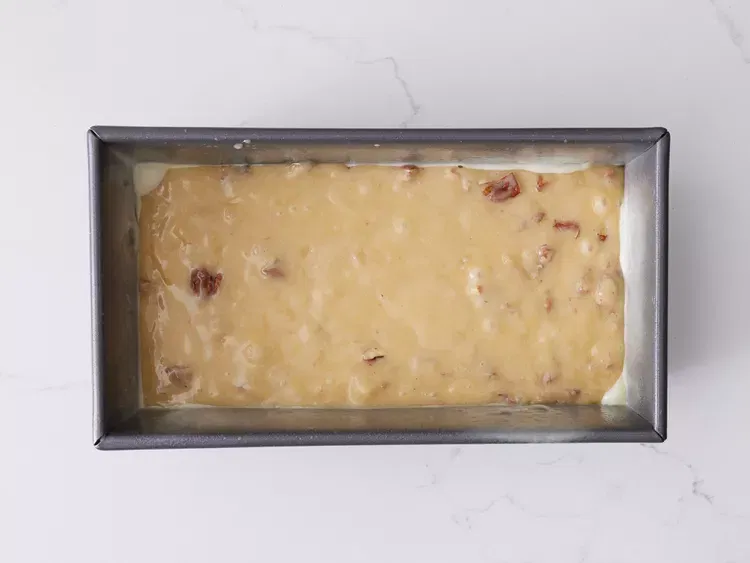 Image of Pour batter into the prepared loaf pan.
