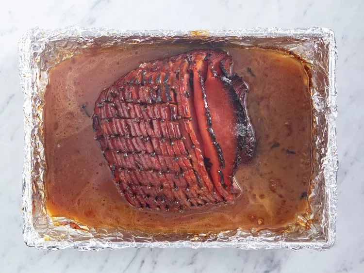 Image of Baste ham every 10 to 15 minutes with the honey glaze. During the last 4 to 5 minutes of baking, turn on broiler to caramelize the glaze. Remove from oven and let sit a few minutes before serving.