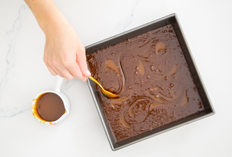 Image of Spoon about 10 small dollops of caramel over the batter....