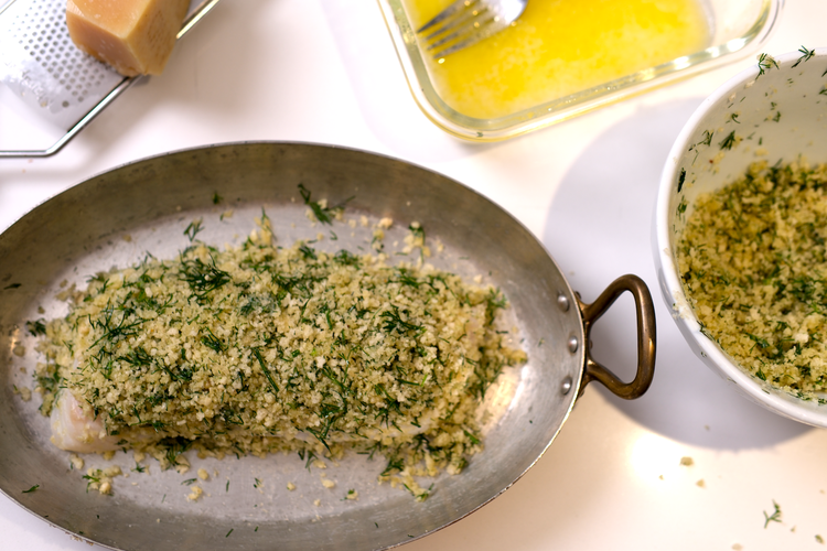 Image of With your hands, pat on a generous amount of the panko mix and pack gently but firmly onto the fish to create a layer over the full fillet. The panko mix should all be used to cover both of the...