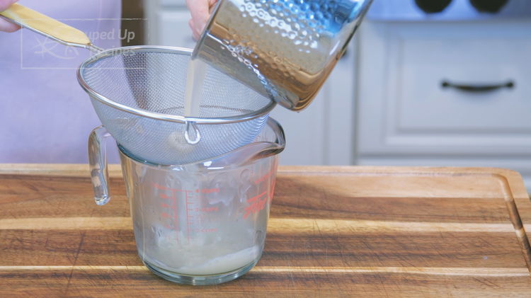 Image of Pour the soup through a sieve into a measuring cup....