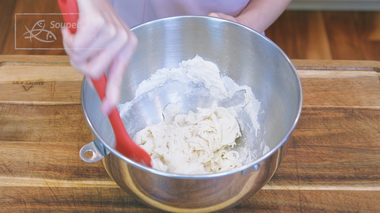 Image of Add the salt to the water and stir to dissolve. Add the bread flour to a stand mixer’s bowl. Pour the salt solution into the bread flour and stir until all the water is well absorbed.