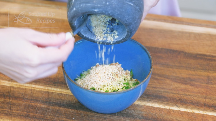 Image of Add the minced scallions, garlic, ginger, white pepper, Sichuan peppercorn powder, and roasted sesame seeds to a heat-proof bowl. I recommend lightly pounding the sesame seeds using a rolling pin to release the nutty flavor before adding to the bowl....
