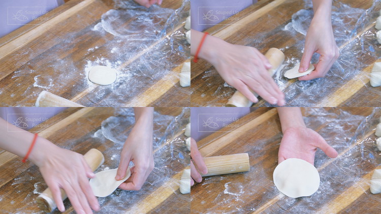 Image of Put one piece of dough on the working surface with the cut cross section facing vertically and flatten it into a small round pancake. One hand uses a rolling pin to roll the edge of the dough back and forth...