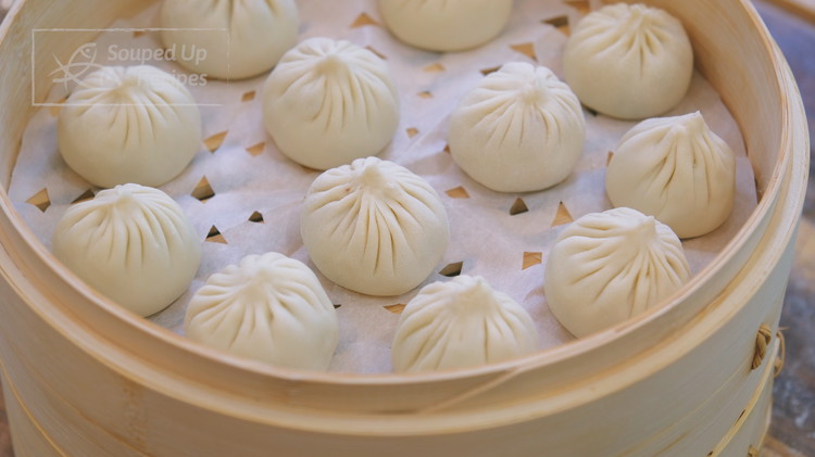 Image of Place the dumplings into a steamer with parchment paper under them to prevent sticking. 