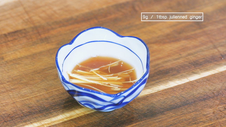 Image of While waiting, make the dipping sauce by combining the soy sauce, apple cider vinegar, and julienned ginger.