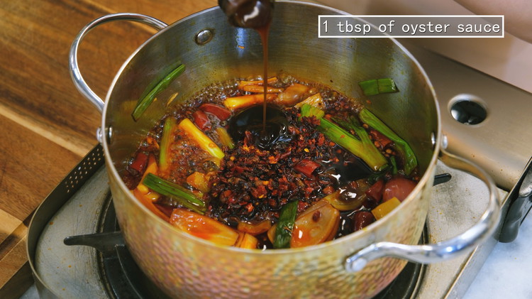 Image of Add 3 Tbsp of of Lao Gan Ma chili crisp in addition, 2.5 Tbsp of soy sauce, and 1 tbsp of oyster sauce. Mix thoroughly.