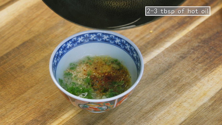 Image of To make a hot pot dipping sauce, add 1 tbsp of minced garlic, 1 tbsp of diced scallions, 1.5 tbsp of diced cilantro, 1/2 tbsp of chili flake, and 1/2 tbsp of toasted sesame seeds. Heat 2-3 tbsp of hot...