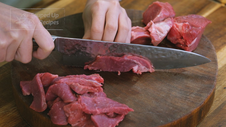 Image of Cut the beef into 1/4-inch thick slices. I am using the top round today. Other cuts, such as flank steak, ribeye, sirloin, and chuck, will also work. 