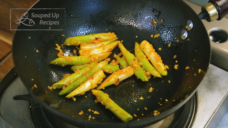 Image of Pour all the oil out of the wok, then add 1/2 Tbsp of oil from the Lao Gan Ma jar, 1 tbsp of minced garlic, 1.5 tsp of minced ginger, and the white parts of the scallion stalks. Stir everything...