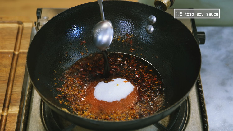 Image of Add 3.5 tbsp of sugar, 1.5 tbsp of Chinese black vinegar, and 1.5 tbsp soy sauce. Stir for a minute.