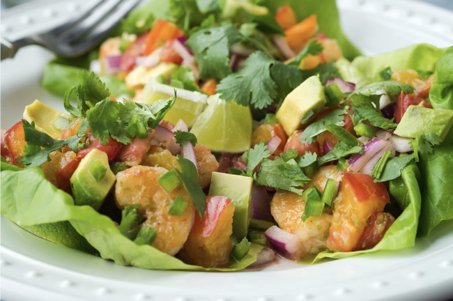Grilled Thai chili shrimp served in lettuce cups with avocado, red onion, and slaw