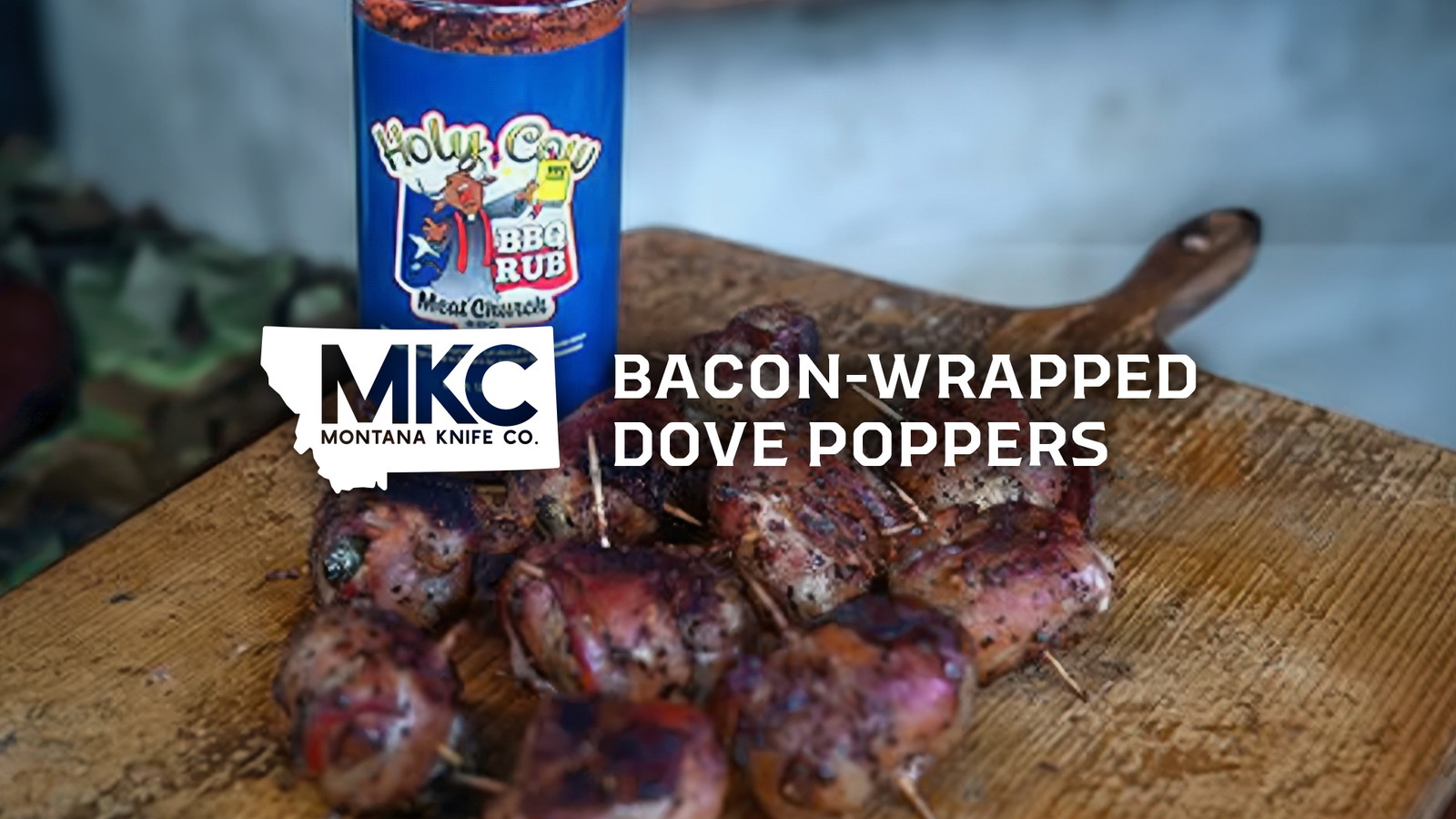 Bacon-wrapped dove poppers on a wooden board with Holy Cow BBQ Rub in the background.
