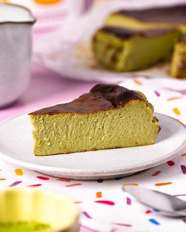 A slice of perfectly fluffy centred matcha Basque cheesecake with a caramelised top