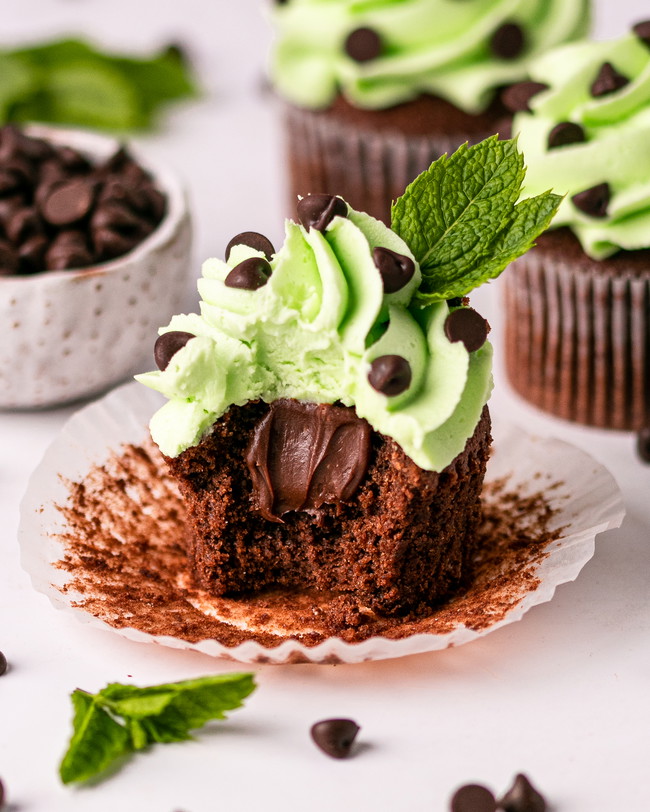 A chocolate cupcake with a gooey chocolate ganache centre, topped with mint buttercream and chocolate chips