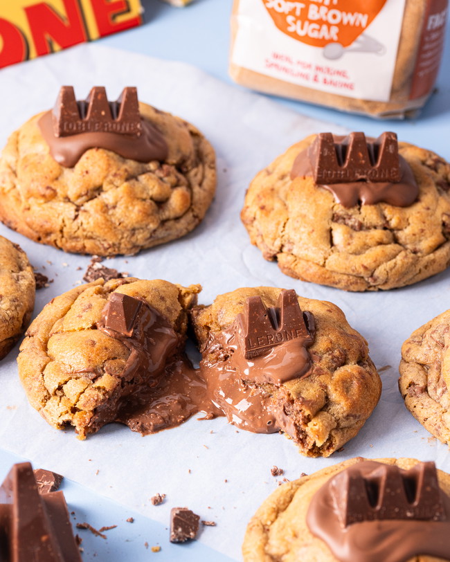 A tray of chocolate chip cookies with a gooey chocolate nougat and almond centre.