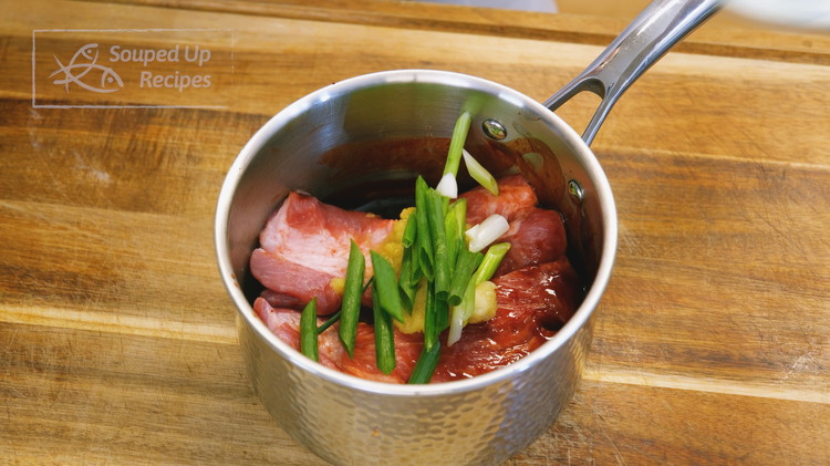 Image of Mix the pork with the char siu sauce along with 2 tsp of garlic paste, 1 tsp of ginger paste, and 2 scallions that I cut into stalks. Cover well and let it sit in the fridge overnight.
