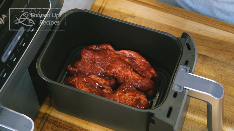 Image of The next day, no need to preheat the air fryer. Put the pork in the air fryer basket and cook at 300F for 18 minutes.