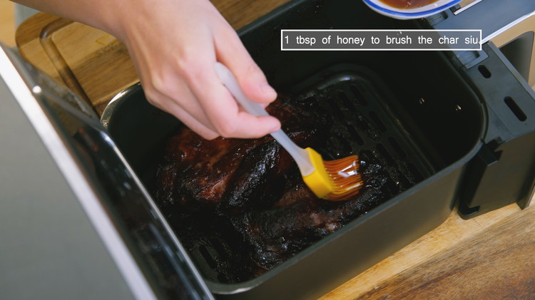 Image of Pull out the air fryer basket again and brush a thin layer of honey, which gives the char siu a shiny and tempting appearance. Stick it back into the air fryer. Increase the temperature to 350F and continue to cook...
