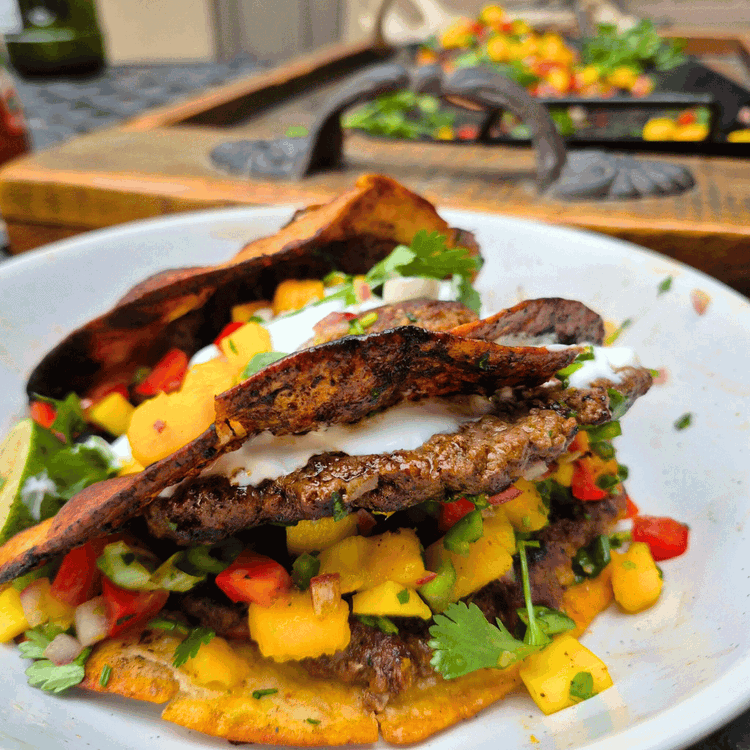 Image of Transfer to plates and pile on the salsa and yogurt sauce. 