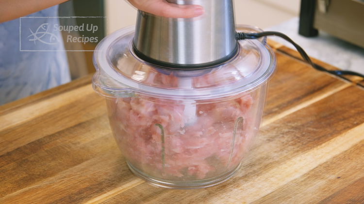 Image of Cut the chicken meat into bite-size pieces. Then, grind it...