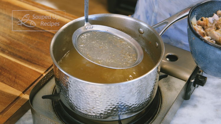 Image of Use a fine sieve to remove all the solid ingredients...