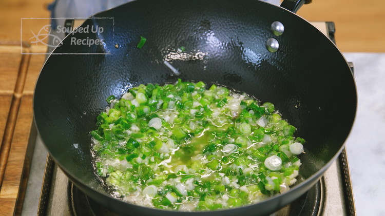 Image of To make the caramelized scallion sauce, add 1/4 cup of vegetable oil, 3 tbsp of diced shallots, 1 cup of diced scallions, and 3 tbsp of diced and rinsed garlic. Cook all the aromatics for 10-18 minutes and stir every...