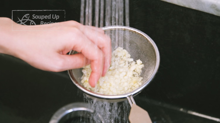Image of Put the diced garlic in a sieve and quickly rinse under running water for 30 seconds, then shake off the access water. The purpose is to wash off the sticky chemical called mercaptans because it will bring a bitter taste...