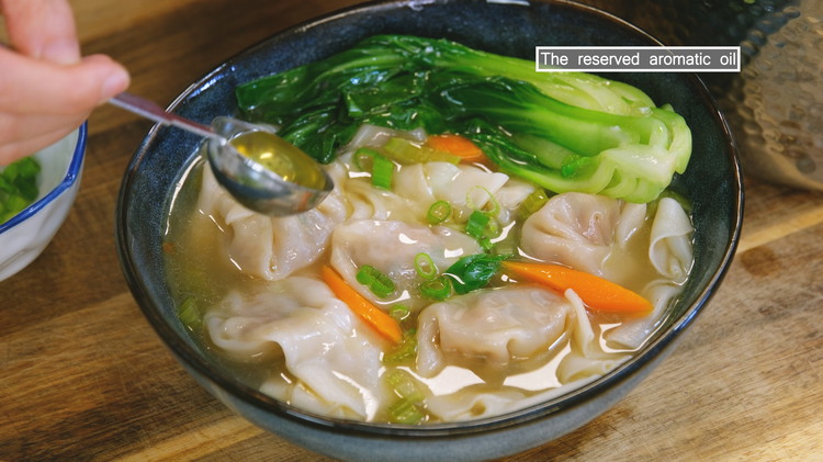 Image of Last, toss in the baby bok choy and blanch for 30 seconds. Before serving, drizzle the reserved aromatic oil in the soup. Enjoy!