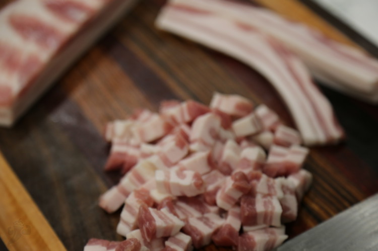 Image of Slice up the pork belly into small chunks and pour over 2 tbsp of the taco mix. Set it aside to let it marinate. 