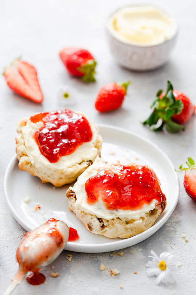 homemade strawberry jam and fresh scones on a plate