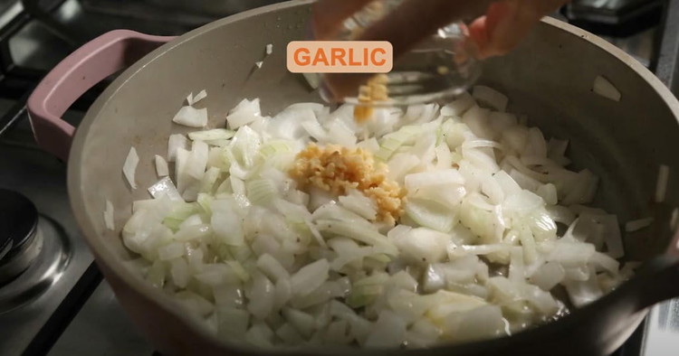 Image of Sauté Onion and Garlic: Add the diced onion to the skillet with the beef. Cook for 3-4 minutes until the onion softens and becomes translucent. Add the minced garlic and cook for another 1 minute, stirring to prevent burning.