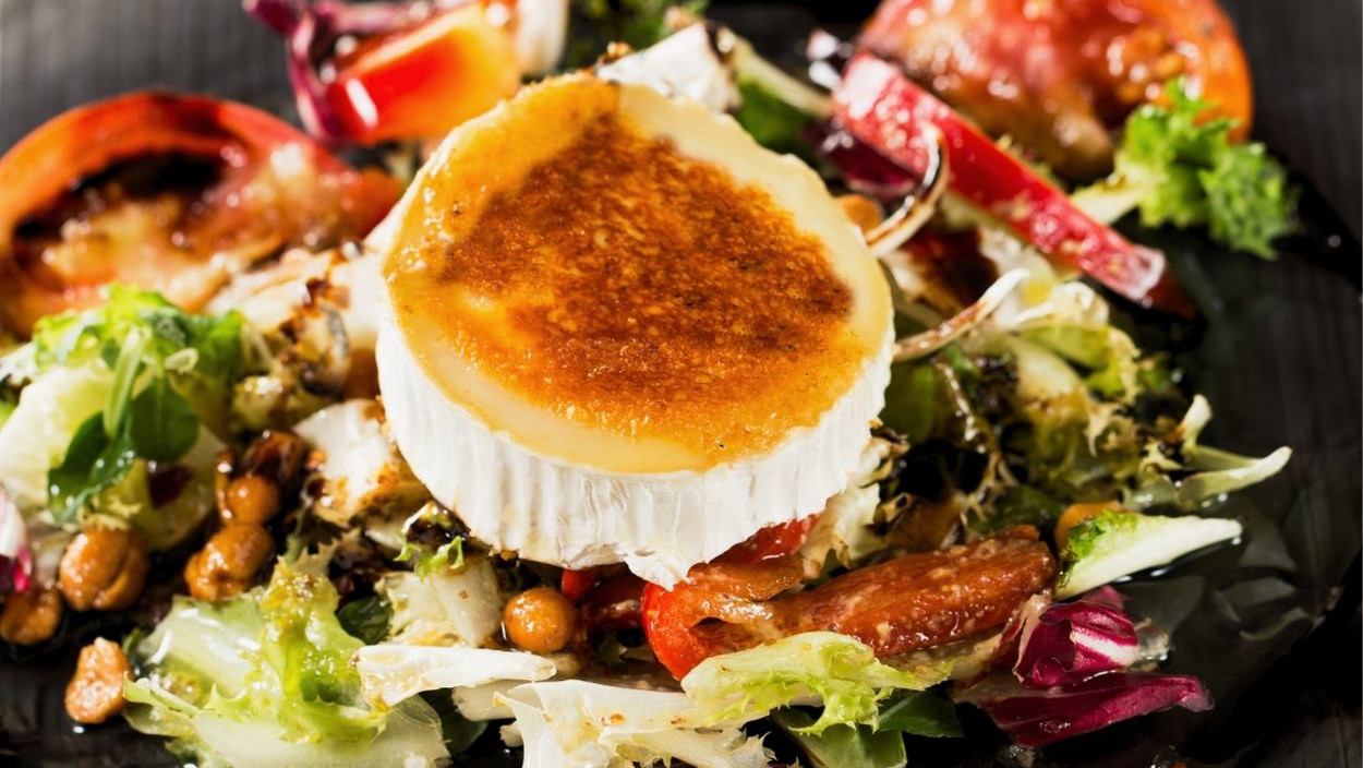 Image of Warm Goat Cheese Salad with Pear & Toasted Nuts 🥗