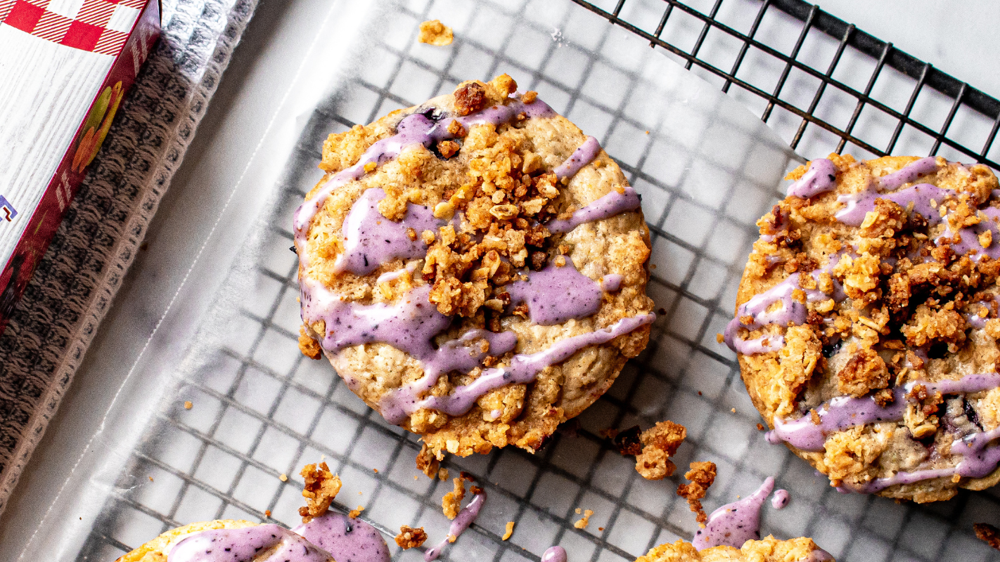 blueberry crumble donuts sit on a cooling rack