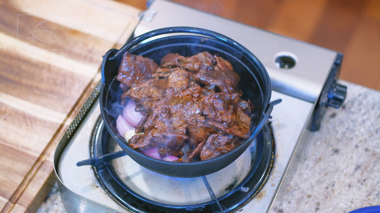 Image of Add the beef to the cast-iron pot, making sure to scrape down the sauce so you don’t waste any flavor. Garnish with diced scallions.