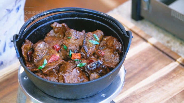 Image of Light a fondue set and continue to heat the cast-iron pot over low heat on the dinner table to keep it sizzling while serving.